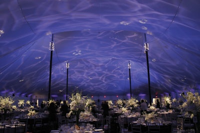 For a benefit for the New York Philharmonic, Bentley Meeker Lighting & Staging Inc. created an elegant ripple effect to complement the event's decor from Van Vliet & Trap, using a wrinkled glass gobo with hues of violet and lavender while dimmed white light shone on the tables.