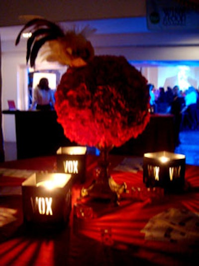 Each of the cocktail tables was draped in red linens, topped with a sphere-shaped arrangement of red roses, and littered with red and white dice.