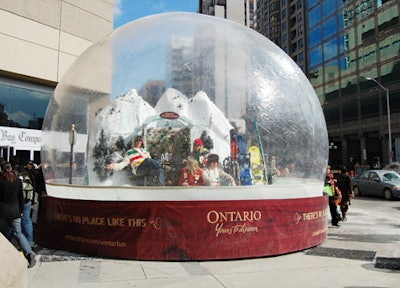 Actors inside the Ontario Tourism Snow Globe—dressed in the Bay's traditional striped garb—waved to passersby on Bloor Street.