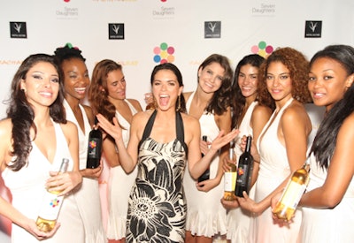 Promotional models from Seven Daughters Winemaker's Blend posed for photographers with Katie Lee Joel on the wine-appropriate purple carpet.
