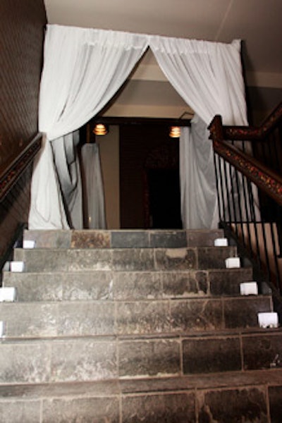 Lit candles led the way to the white-draped entrance on the second floor.