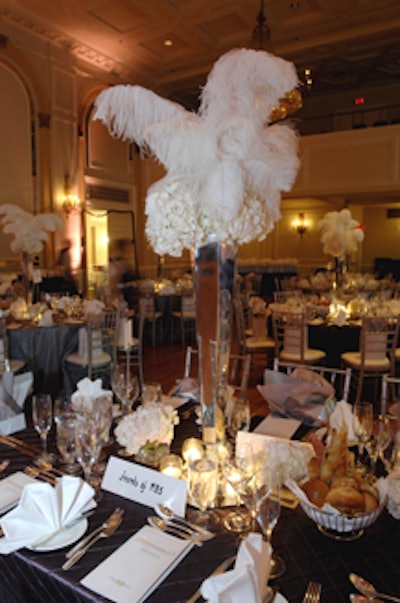 Tall mirrored vases filled with ostrich feathers and hydrangeas served as centrepieces in the dining room and reception area.