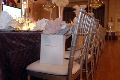 Gift bags filled with MAC cosmetics awaited guests on the silver Chiavari dinner chairs.