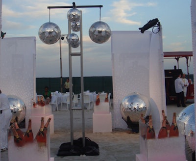 Disco balls hung overhead and around the feet of the models greeting guests at the event entrance.