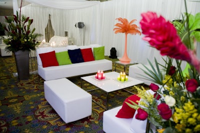 The Elton John-inspired lounge featured elaborate floral arrangements and feathered palm trees in orange and lime green.