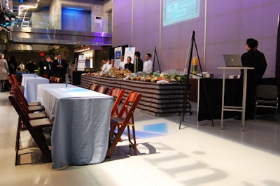 Two exhibitor booths sat on either side of a food station, allowing guests to mingle and chat with exhibitors.