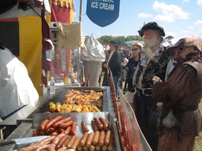 Guests enjoy foods like turkey legs and sausage.