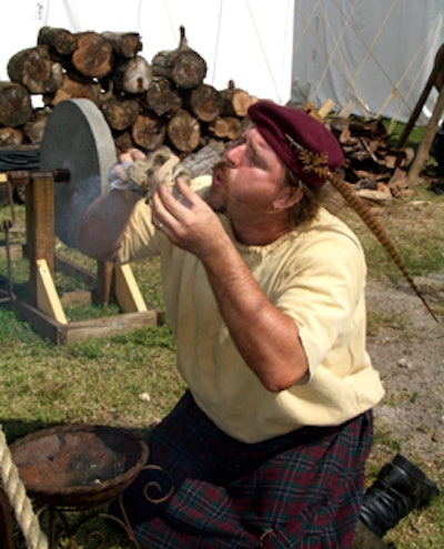 A performer demonstrates how to ignite fire using flint and steel.
