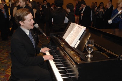 Jazz singer and pianist John Alcorn played at the event's cocktail reception.