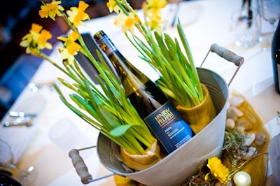 Garden-pail centrepieces held yellow daffodils and bottles of riesling.