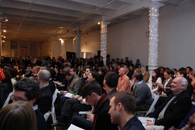 The guests filled the seats quickly, while many others had to stand for the auction.