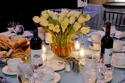 White tulips in simple glass vases topped each table.