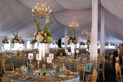 The tables inside the tent were clad in luxurious blue and gold damask linens provided by BBJ Linen.
