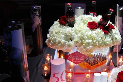 Retro Coke pails filled with flowers and bottles topped some of the dinner tables.