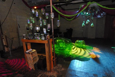 Apothecary jars filled with mad-scientist-style curiosities flanked an area with Astroturf and neon green blowup chairs.