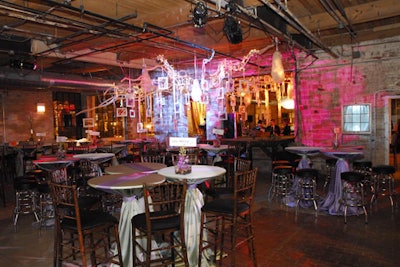 Tall cocktail tables topped with lavender and sage green linens and simple floral arrangements of orchids and river stones provided guests with a place to perch and watch the evening's proceedings.