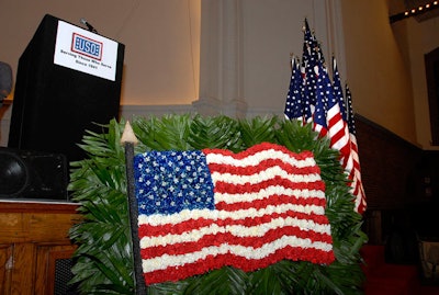 Floral arrangements throughout the ballroom comprised boxwood topiary and American flag embellishments.