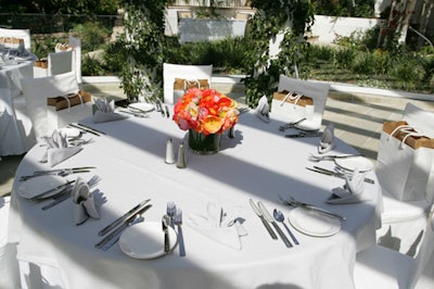 The spare decor included white linens and bright flowers.