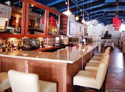 Cream-colored leather stools provide seating at the small granite-topped bar on the main floor.