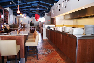 A small open kitchen, complete with a tandoor oven, is situated across from the bar on the main floor.