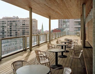 A rooftop terrace features pale wood boards, metal beams, and glass panels.