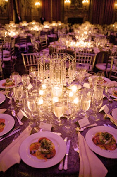 In addition to the elegant centerpieces, designer H. Devinn Bruce scattered crystals atop the silver tablecloths for an overall shimmering effect.
