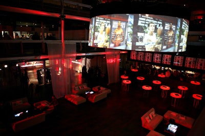Amid red and black lighting and decor, the covers of the magazine were splashed across many surfaces of the venue. The event's tagline and logo were projected onto sheer drapes that hung in the main room.