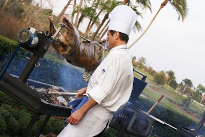 Guests were eager to sample one of the two suckling pigs being slow-roasted outdoors.
