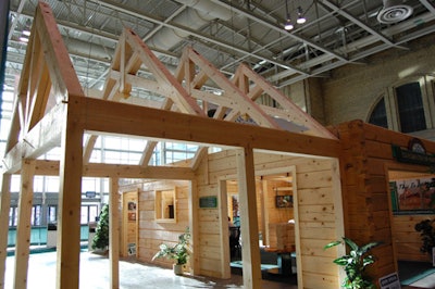 The Confederation Log Homes booth was a partially constructed log cabin.
