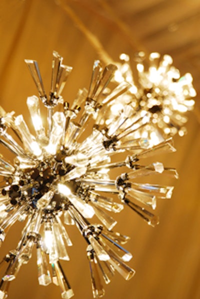 Dangling crystal starburst chandeliers accented the ceiling of the tent.