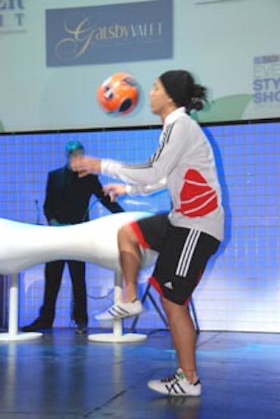 A high kick was demonstrated on the main stage from a member of the Freestyle Soccer Show while DJ Piers of Third From the Sun spun music in the background on the stage set designed by Westbury National Show Systems.