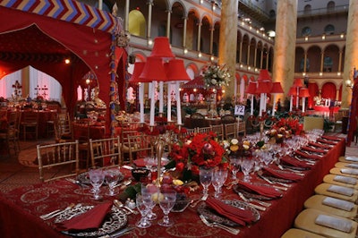 Red linens dominated the tables, with arrangements of roses and gold candelabras topped with mini red lamp shades.
