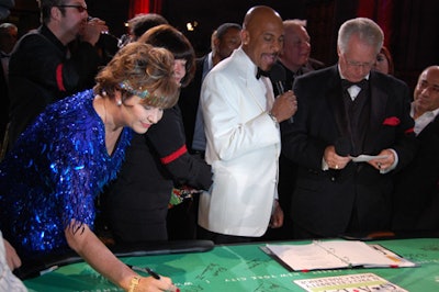 Professional poker players such as Freddy Deeb and Mary Jones signed a poker table during the event.