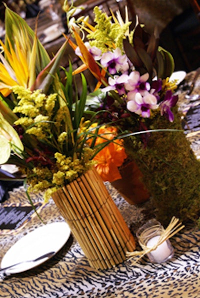 Each table received one of three jungle-inspired centerpieces made with palm fronds and foliage.