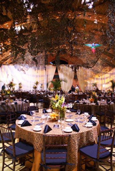 The ceiling was draped in an elegant combination of camouflage and strings of pin lighting, and tables were covered in layers of animal-print linens.