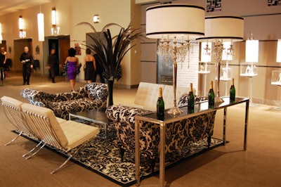 The Carlu's grand foyer featured four seating areas including black-and-white chaise lounges and smoked glass and chrome tables topped with tall white lamps and bottles of Moët & Chandon champagne.