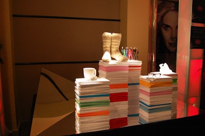 A display honouring fashion writer David Livingstone featured stacks of paper topped with various personal objects, including a coffee mug, pens, a pair of eyeglasses, and a pair of wool socks.
