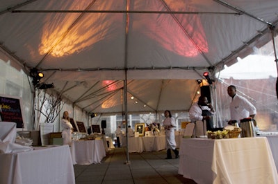 To contrast the stark white of the museum's interior, Event Creative used red and orange spotlights to illuminate the tent covering the back patio.