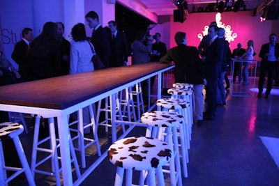 ying back to the idea of Southern rock and blues, cowhide-patterned fabric covered the tops of stools in one area.