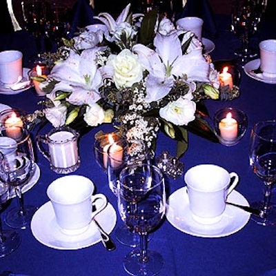 On the tables, stark white centerpieces by Botanica Inc. provided a nice contrast to the bright blue tablecloths.