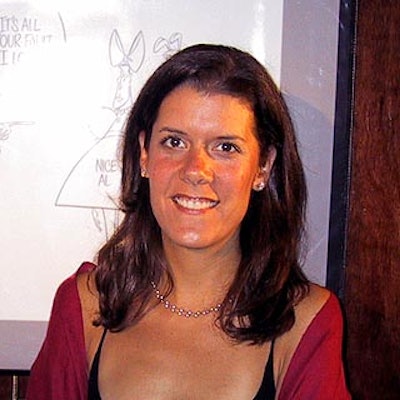 The event's publicist, Julianna Evans, posed in front of some of the cartoons that were up for auction.