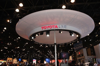 Within Toyota's sizable booth was a circular platform—complete with 'On Air' signs, bright lights, and seating—in which the hourly Toyota Live broadcast took place.