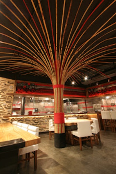 Ippudo's main dining room features a large bamboo tree.
