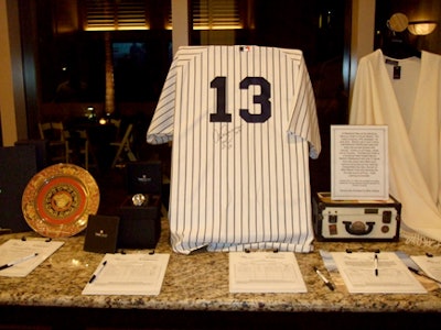 Auction items included Versace wine glass and designer plate sets, an Alex Rodriguez autographed jersey, and a Caribbean cruise.