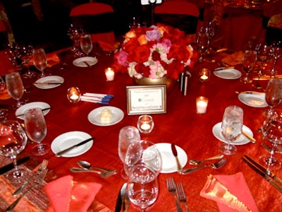 Rich tones marked the event. All tables alternated between a fuchsia and chocolate tone for the linens and bore a centerpiece of roses in varying colors.