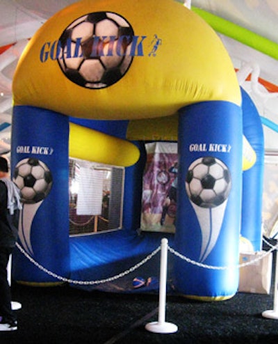 Kids attempted to make a goal at an inflatable soccer station.