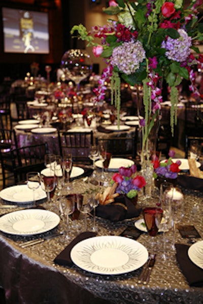The tables featured silver sequined tablecloths and three-foot-high floral arrangements.