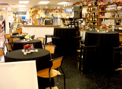 The café tables were draped in black linens and topped with compact arrangements of brightly colored flowers.