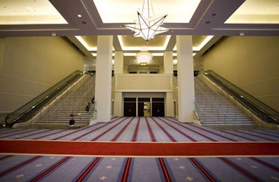 The three-floor convention center features subtle decor in red, white, and blue, with star chandeliers.
