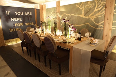 Marc Blackwell's dining room for Beringer incorporated humble materials like burlap with shirting fabrics and velvet on the chairs, and rich, natural wood on the table and walls, with mossy accents on the table.